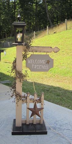 a wooden welcome sign with a star on it