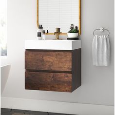 a bathroom with a sink, mirror and towel rack on the wall next to it