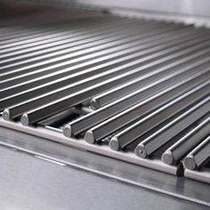 stainless steel grill grates are lined up and ready to be cooked