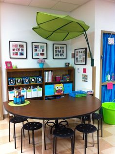 a classroom with an umbrella over the table