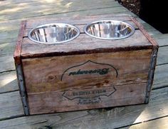 an old wooden box with two bowls in it