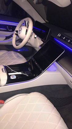 the interior of a modern car with blue lights