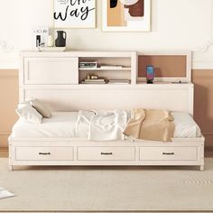 a bedroom with a bed, bookshelf and two pictures on the wall above it