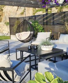 an outdoor living area with furniture and plants