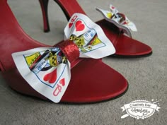 a pair of red shoes with a white bow on the heel and an i love you sticker on the shoe