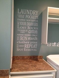 a laundry room wall decal with words written in white on the back of it