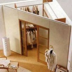 an overhead view of a closet with clothes on hangers and a chair next to it