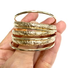 Baby 7 days bangles set is make with 14k gold filled wire. Bangle is hand- formed, hammered into a faceted design and polished for a stunning texture and shine. It looks great worn alone or stack with other shell and charm bangles to create a chic, fun beachy look. This set come with 3 heirloom bangles and 4 textures bangles. Each bangle is custom made to order so can not be return or exchange for that reason. Charm Bangles, Fancy Jewelry Necklace, Faceted Design, Bangles Set, Tarnished Jewelry, Luxe Jewelry, Jewelry Safe