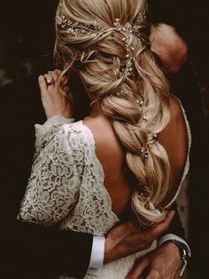 the back of a bride's head as she hugs her groom