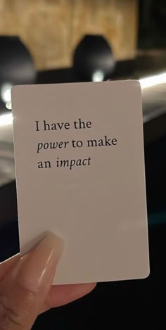 someone holding up a piece of paper that says i have the power to make an impact