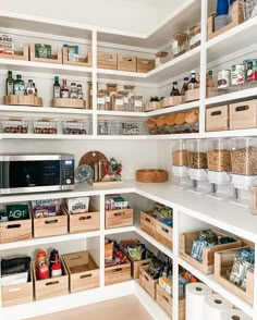 an organized pantry with wooden boxes and baskets