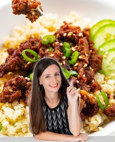 a woman sitting in front of a plate of food with meat and vegetables on it