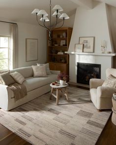 a living room filled with furniture and a fire place