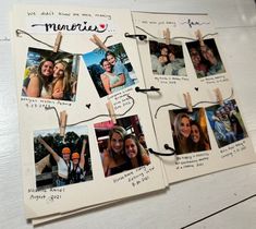 several pictures hanging from clothes pins on a white table with black string attached to them