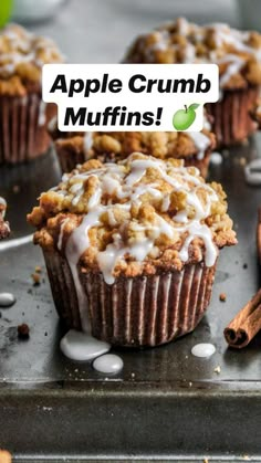 apple crumb muffins on a baking sheet with cinnamon sticks