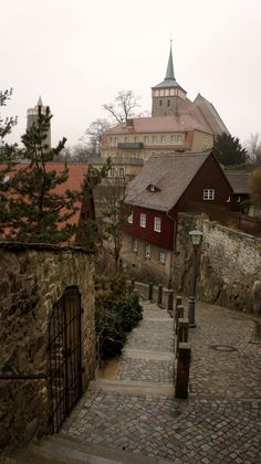 an old cobblestone street leading to a church