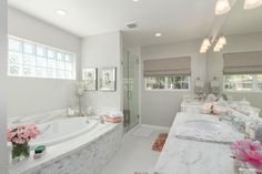 a large bathroom with two sinks and a bathtub