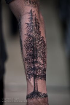 a man's arm with trees on it