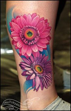 a woman's leg with pink flowers on the side of her body and green eyes