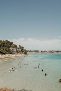 many people are on the beach and in the water at this point, there is no image here