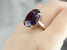 This ring is truly gorgeous! A large and beautiful purple Amethyst sits in the center, with an amazing cut and vibrant purple color that flickers with hints of violet and raspberry, a simple yellow gold mounting and four prongs are all this stone needs to frame it to perfection! Metal: 14K Yellow Gold Gem: Amethyst 15.00 Carats Gem Measurements: 19 x 15.6 mm, Oval Ring Size: 8 Marks: "14K WNG" Stamped on the inside band Luxury Gold Amethyst Ring, Luxury Gift Oval Cabochon Amethyst Ring, Luxury Oval Amethyst Ring, Luxury Handmade Gold Amethyst Ring, Amethyst Cocktail Ring, Right Hand Ring, Cameo Ring, Right Hand Rings, Hand Ring