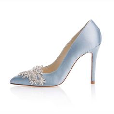 a blue high heeled shoe with an embellishment on the front and side