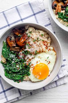 two bowls filled with rice, spinach and an egg on the side next to each other