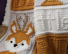 a crocheted blanket with animals on it