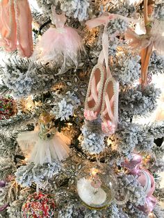 a christmas tree with ballet shoes hanging from it's sides and ornaments on the top