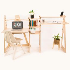 a laptop computer sitting on top of a wooden desk next to a chair and book shelf