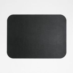 a black mouse pad sitting on top of a white surface