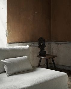 a white couch sitting next to a wooden table