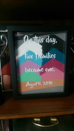 a framed sign that says, on this day two families become one august 6, 2016