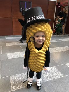 a young child dressed in a costume made to look like a corn cob