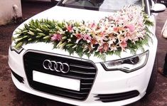 an audi car decorated with flowers and greenery