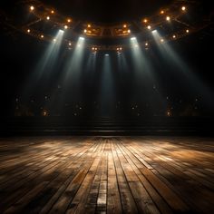 an empty stage with spotlights shining down on the wooden floor and lighting from above