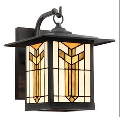 a light that is on the side of a wall mounted fixture with stained glass panels