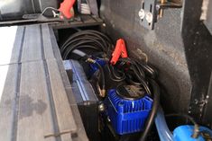 an image of some wires in the back of a truck with other items on it