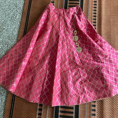 Pink Silk Skirt With Golden Printed Design. Skirt Comes With Attached Ornaments And Cancan. Minimum 8 Meteres Of Flare. It Is One Size Fits All. Can Be Styled With White Basic Or Satin Shirt Or It Can Be Also Styled With Crop Tops Or Blouses (Yellow, Blue, Gold, Or White Colored Blouses). Price Is Negotiable Traditional Lehenga With Tiered Skirt For Reception, Traditional Lehenga For Reception With Tiered Skirt, Traditional Tiered Lehenga For Reception, Elegant Skirt For Reception, Elegant Skirt Set For Reception And Navratri, Traditional Choli With Zari Work And Tiered Skirt, Elegant Navratri Skirt For Reception, Elegant Traditional Drape Skirt For Party, Elegant Party Skirt With Traditional Drape