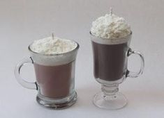 two glasses filled with hot chocolate and whipped cream