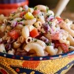 a colorful bowl filled with macaroni salad