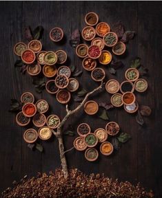 a tree made out of bowls filled with spices