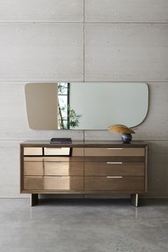 a dresser with a mirror on top of it