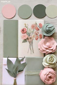 a table topped with lots of different types of paper flowers and paint swatches on top of each other