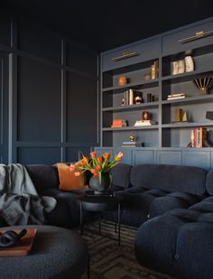 a living room filled with furniture and bookshelves