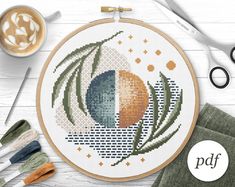 a cross stitch pattern with scissors and other crafting supplies