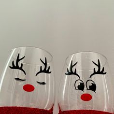 two wine glasses with reindeer noses and red glitter on the bottom, one is empty