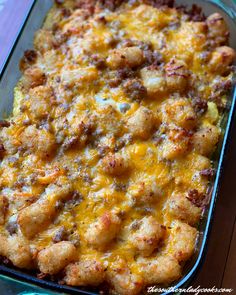 a casserole dish with tater tots and cheese on top, ready to be eaten