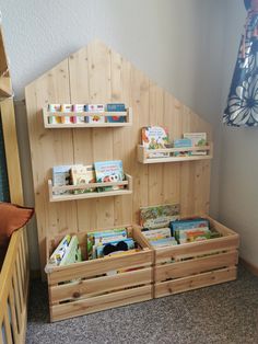 the bookshelf is made out of wood and has three bins for children's books