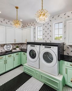 a washer and dryer in a kitchen with green cabinets